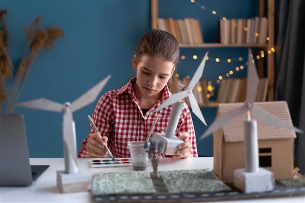 Young student making windmills